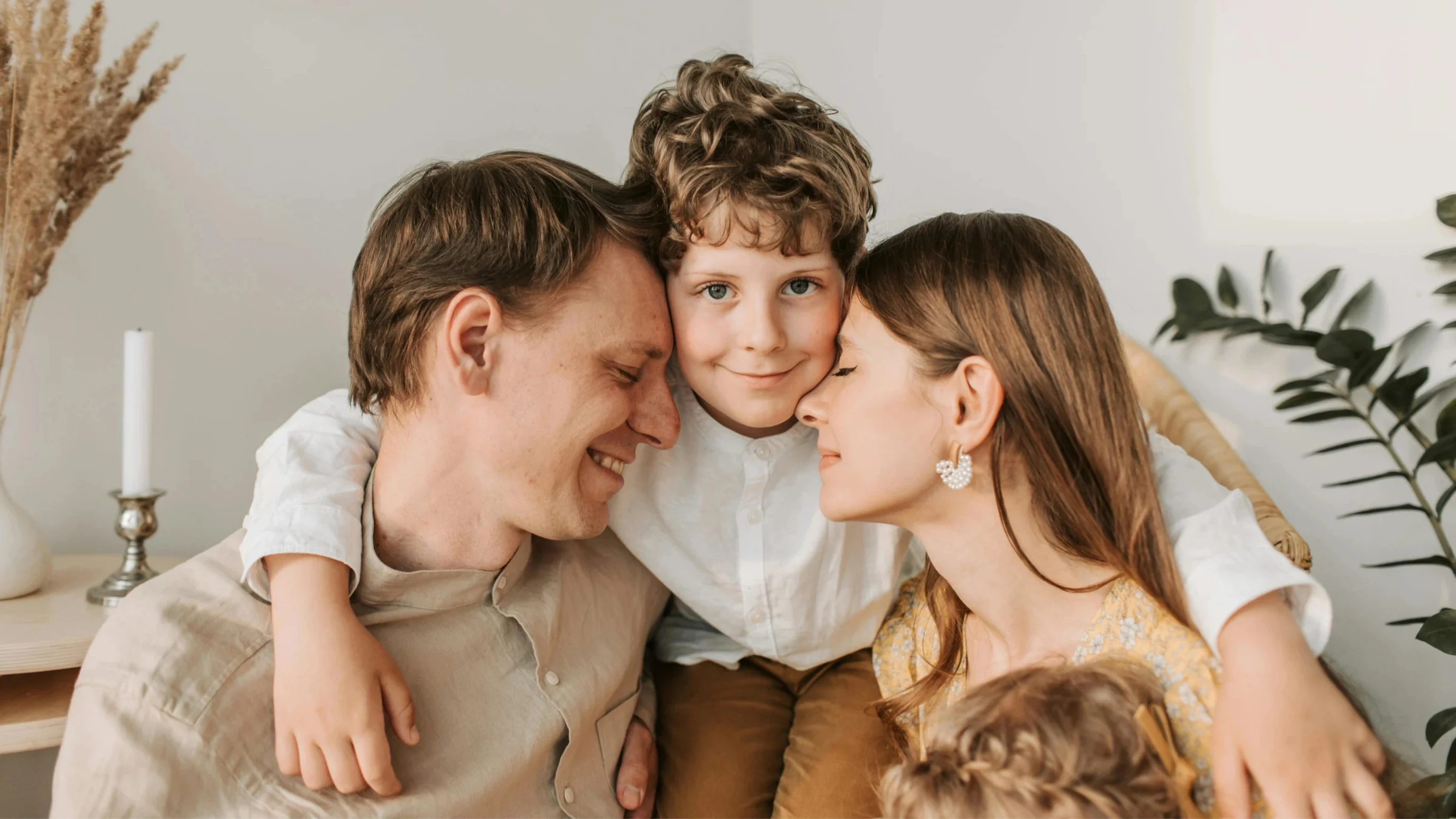 Parents embracing their smiling son at home